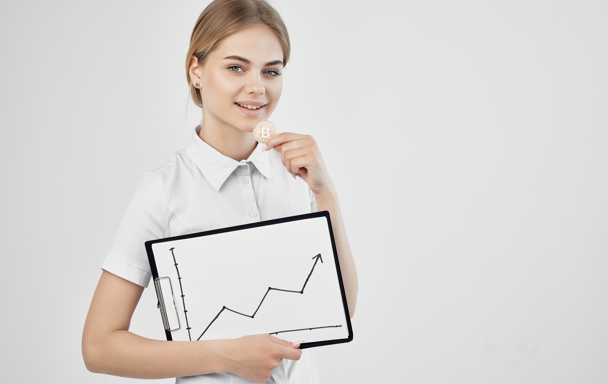 cheerful woman in white shirt cryptocurrency coin electronic money raising