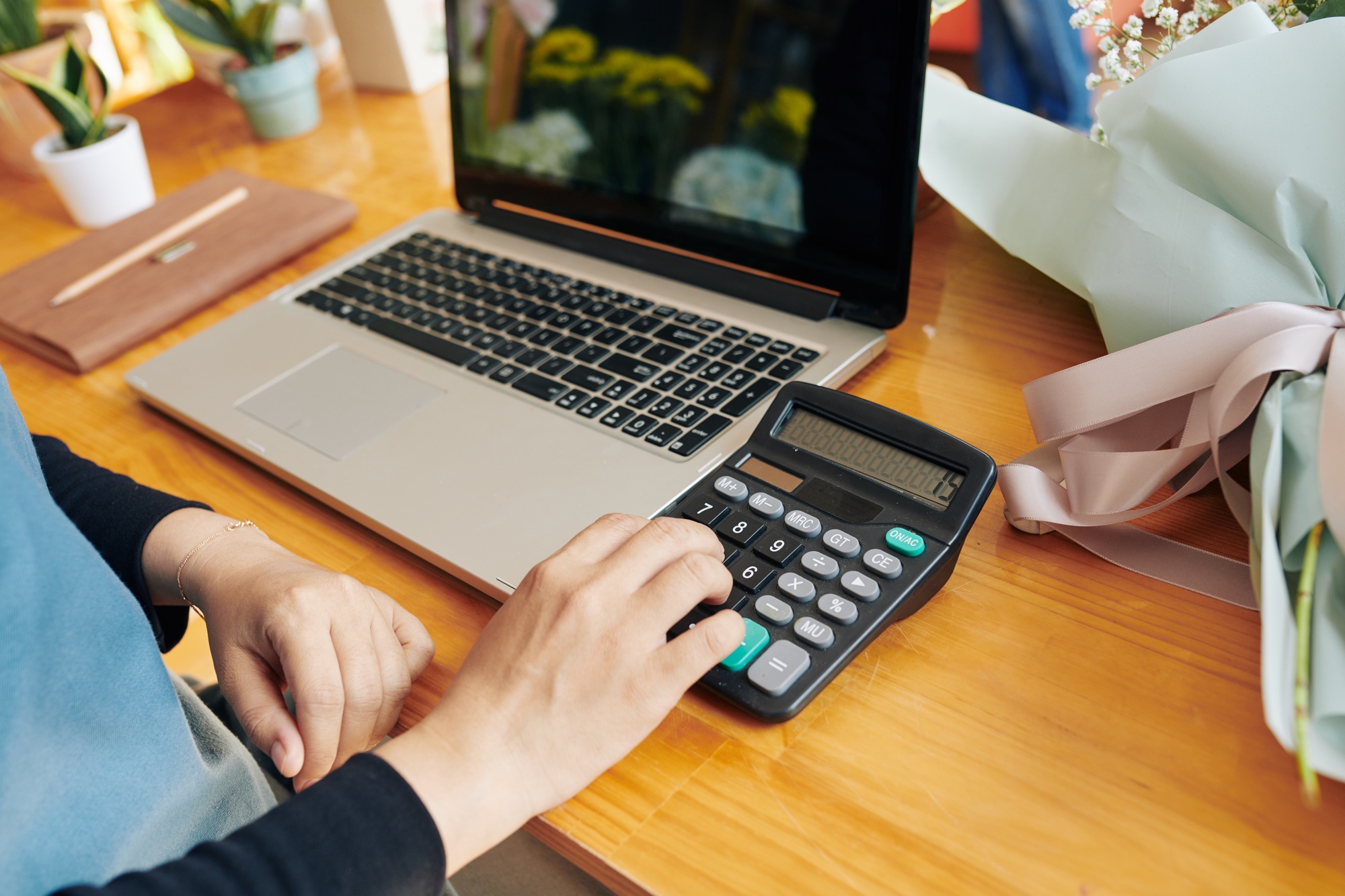 Shop owner calculating price of bouquet
